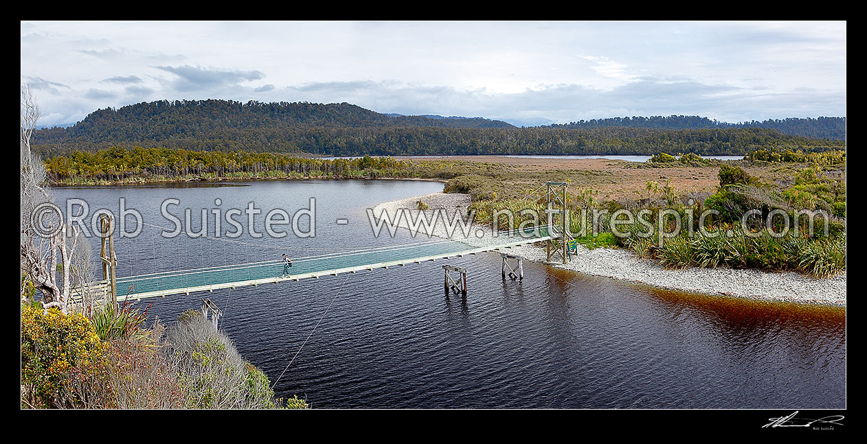 Image of Three Mile Lagoon and swingbridge on the Three Mile pack track walk from Okarito. Panorama, Westland / Tai Poutini National Park, Westland District, West Coast Region, New Zealand (NZ) stock photo image