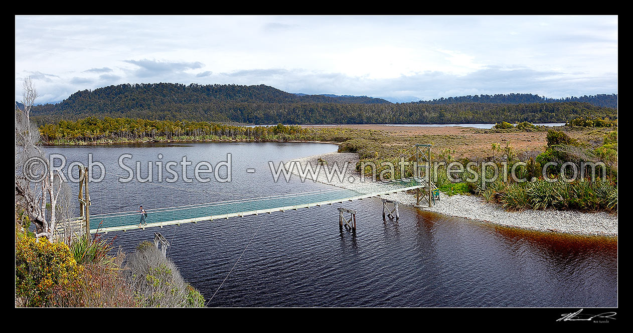 Image of Three Mile Lagoon and swingbridge on the Three Mile pack track walk from Okarito. Panorama, Westland / Tai Poutini National Park, Westland District, West Coast Region, New Zealand (NZ) stock photo image