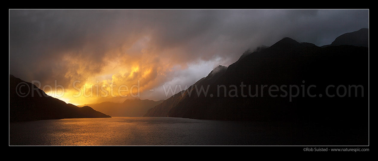 Image of Acheron Passage stormy sunset, looking towards Breaksea Sound. Resolution Island left. Panorama, Breaksea Sound, Fiordland National Park, Southland District, Southland Region, New Zealand (NZ) stock photo image