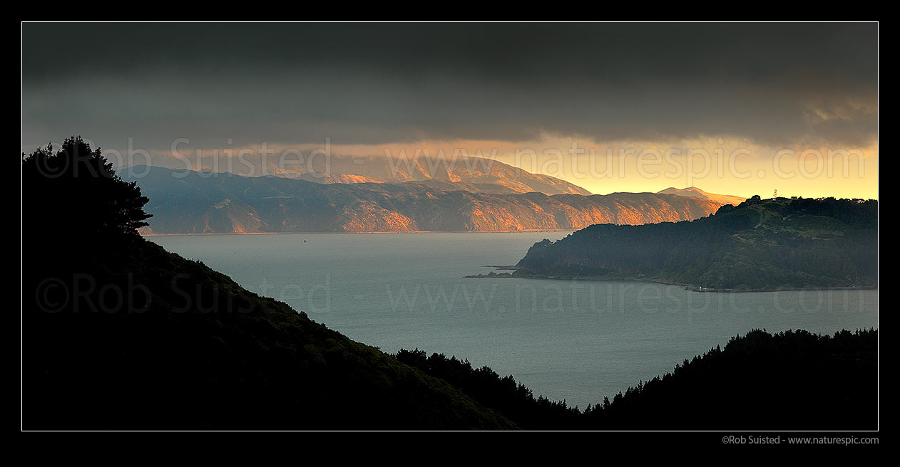 Image of Breaking weather over Wellington Harbour. Post southerly storm sunlight lighting Pencarrow Head and Eastbourne Coast. Point Halswell left. Panorama, Wellington Harbour, Wellington City District, Wellington Region, New Zealand (NZ) stock photo image