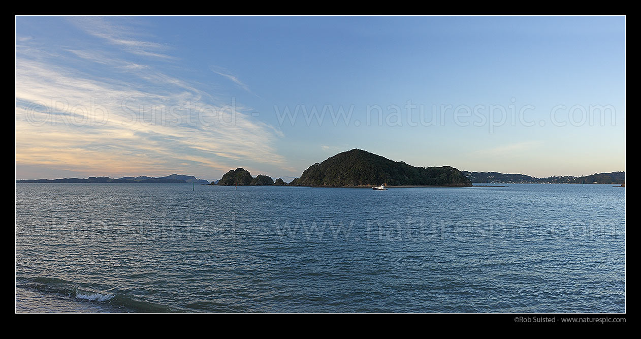 Image of Bay of Islands panorama with Motumaire Island and moored game fishing boat. Russell at far right, Pahia, Bay of Islands, Far North District, Northland Region, New Zealand (NZ) stock photo image