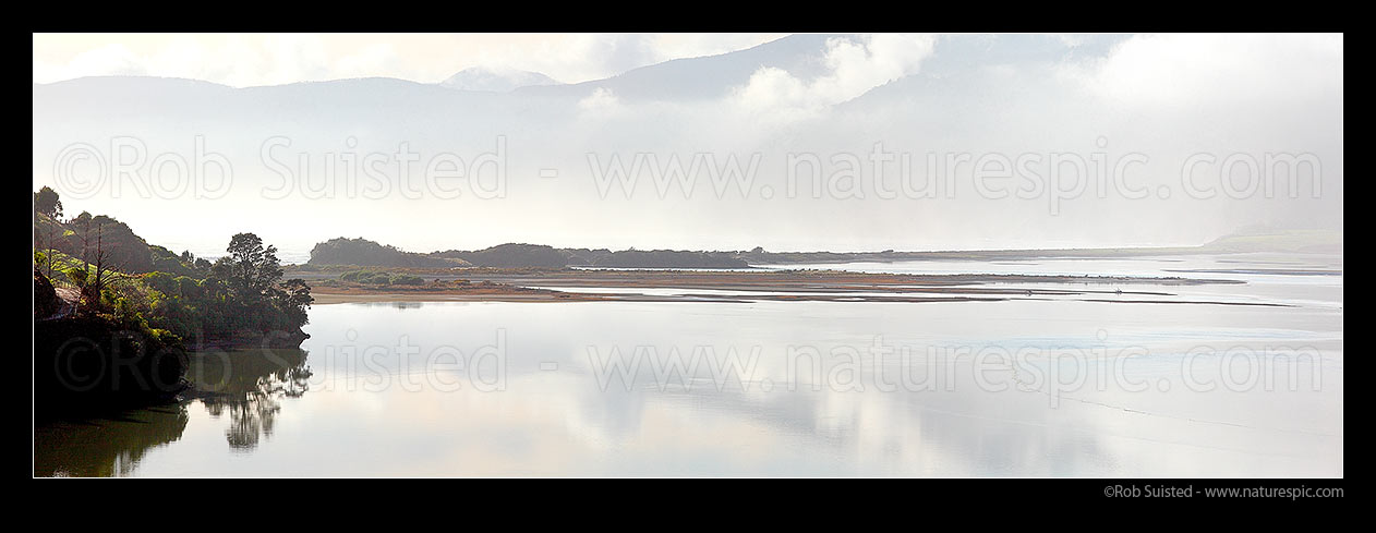 Image of Maori Pa Beach isthmus between Pepin Island (left) and Delaware Bay (beyond) & distant Bryant Range in mist. Panorama, Cable Bay, Nelson City District, Nelson Region, New Zealand (NZ) stock photo image