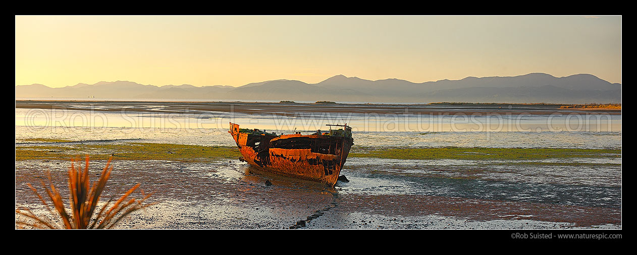 Image of Wreck of the Jaine Seddon on Motueka foreshore. As an Examination Vessel for Wellington Harbour during the World Wars it's said she fired the first shots of the WWII. Panorama, Motueka, Tasman District, Tasman Region, New Zealand (NZ) stock photo image