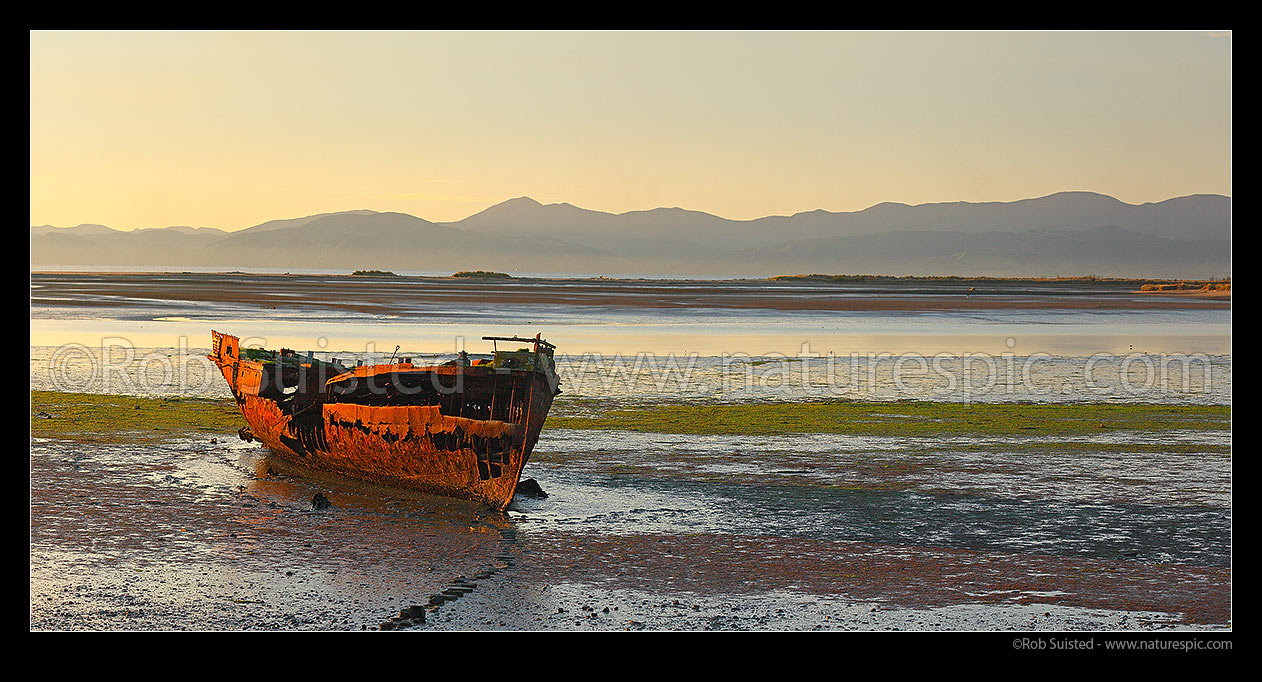 Image of Wreck of the Jaine Seddon on Motueka foreshore. As an Examination Vessel for Wellington Harbour during the World Wars it's said she fired the first shots of the WWII. Panorama, Motueka, Tasman District, Tasman Region, New Zealand (NZ) stock photo image