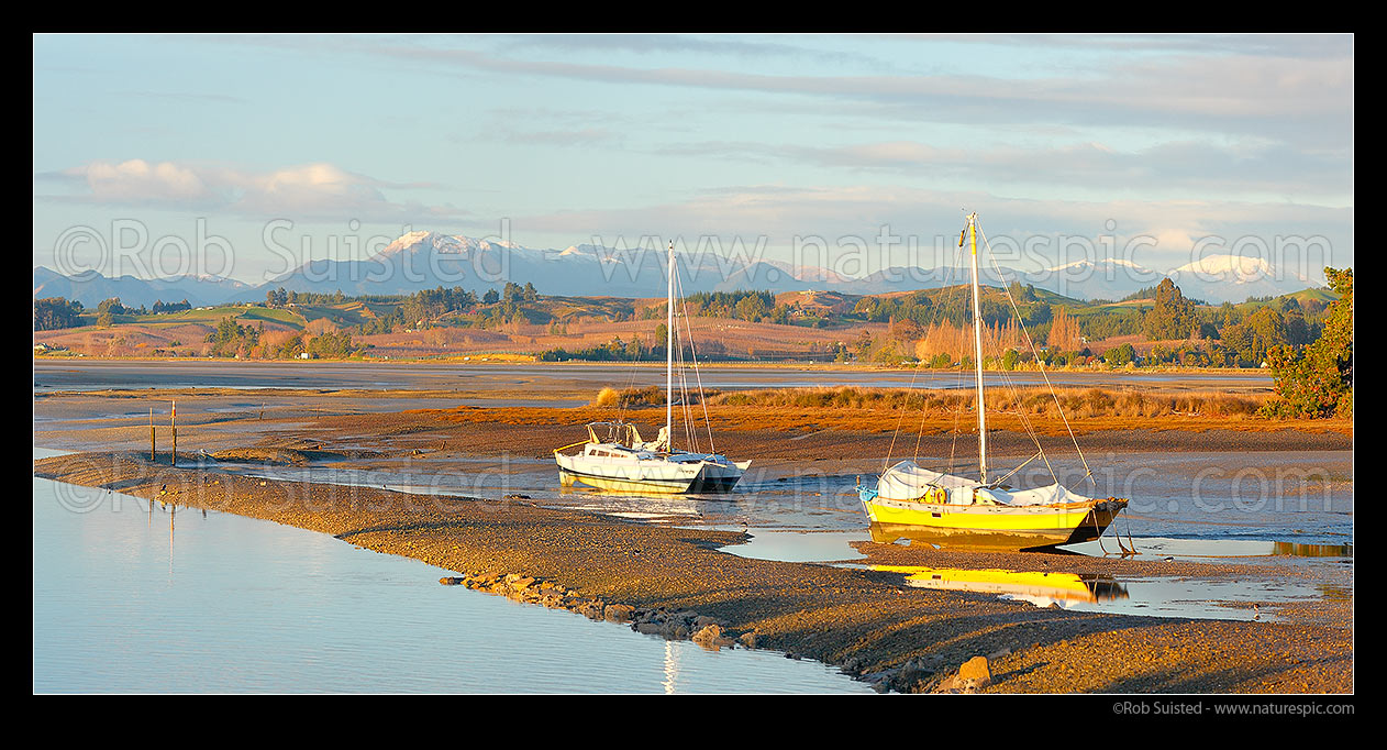 Image of Port Motueka with boats moored in Moutere Inlet at low tide. Richmond Range in distance. Panorama, Motueka, Tasman District, Tasman Region, New Zealand (NZ) stock photo image