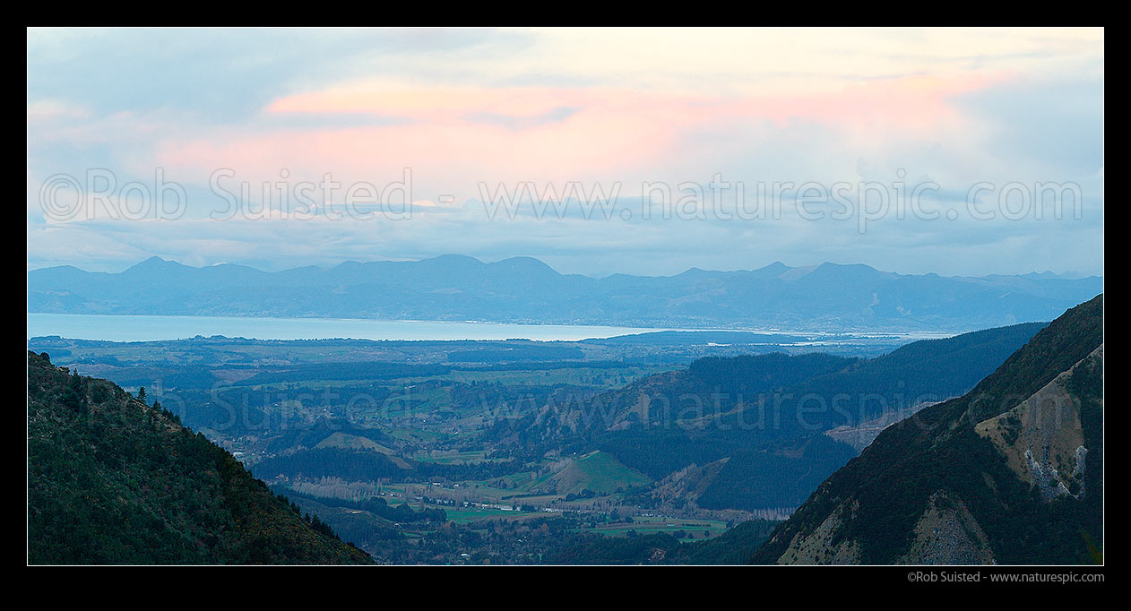 Image of Tasman Bay panorama on a cold winter evening from Kahurangi National Park. Looking over Upper Moutere and Motueka Valley towards Nelson and Richmond Range beyond, Motueka, Tasman District, Tasman Region, New Zealand (NZ) stock photo image