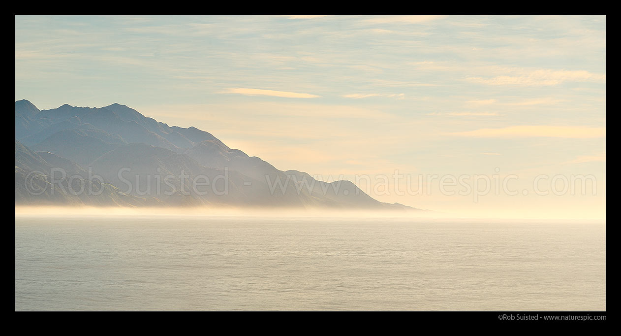 Image of Kaikoura coast north to Clarence River with sea mist in morning light. Panorama, Kaikoura, Kaikoura District, Canterbury Region, New Zealand (NZ) stock photo image