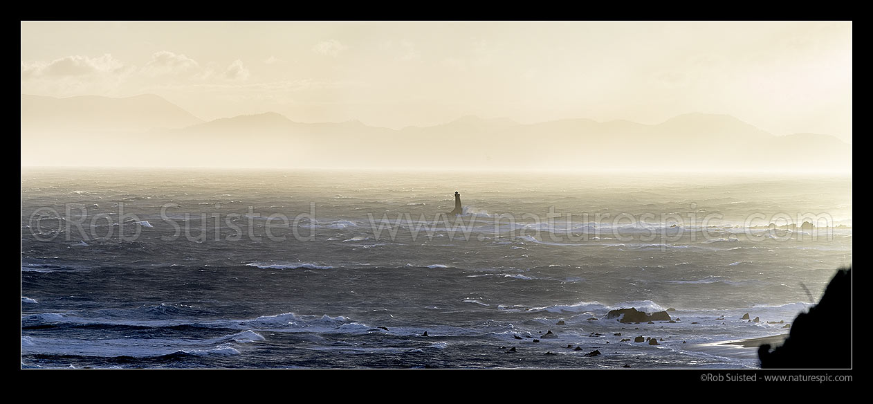 Image of Winter storm winds in Cook Strait. Karori Rock lighthouse off Tongue Point in gale force winds. South Island beyond. Panorama, Wellington South Coast, Wellington City District, Wellington Region, New Zealand (NZ) stock photo image