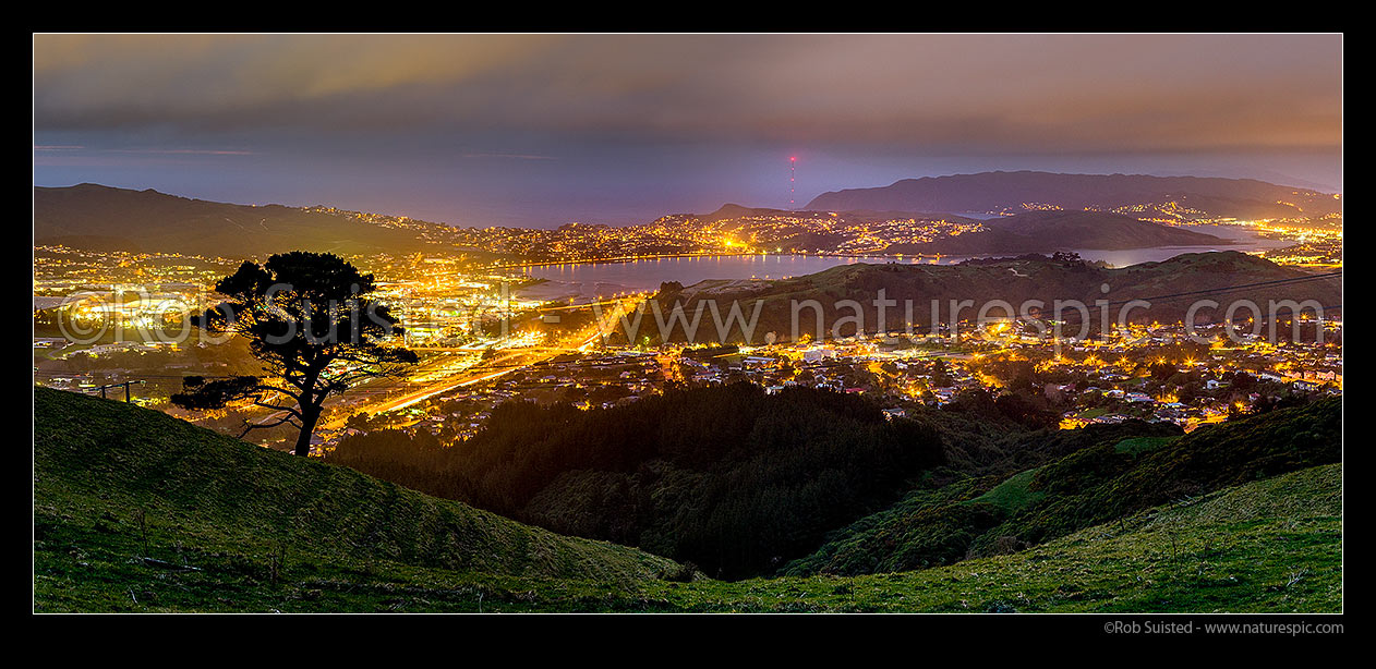 Image of Porirua City and harbour at night from above Rainui Heights. Titahi Bay distant, and Porirua East, Cannons Creek at right. Panorama, Porirua, Porirua City District, Wellington Region, New Zealand (NZ) stock photo image