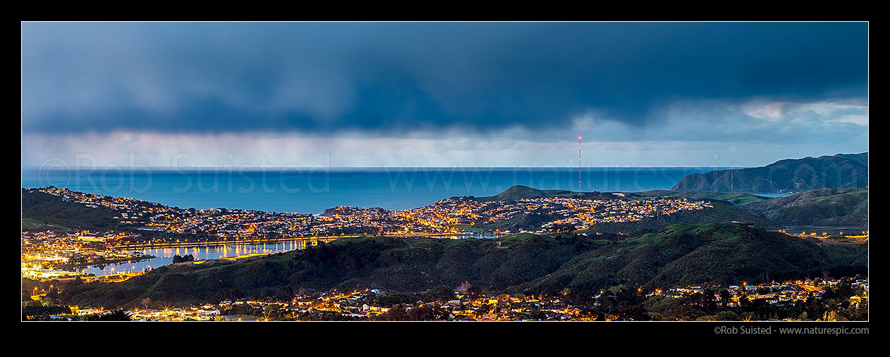 Image of Porirua City (left) and Harbour at twilight. Porirua East and Cannons Creek in foreground, Takapuwahia and Titahi Bay and Cook Strait beyond. Panorama, Porirua, Porirua City District, Wellington Region, New Zealand (NZ) stock photo image