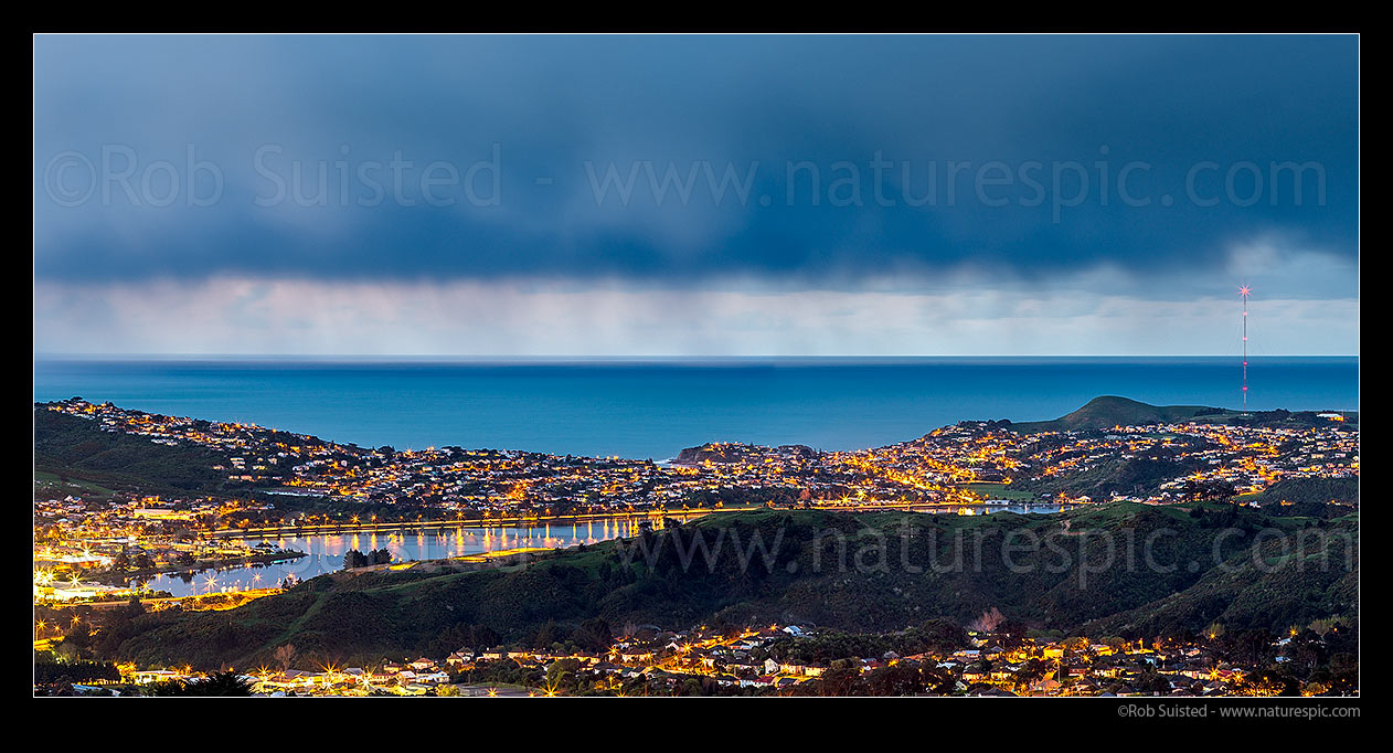 Image of Porirua City (left) and Harbour at twilight. Porirua East and Cannons Creek in foreground, Takapuwahia and Titahi Bay and Cook Strait beyond. Panorama, Porirua, Porirua City District, Wellington Region, New Zealand (NZ) stock photo image