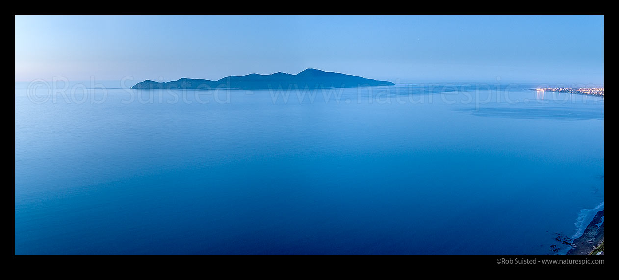 Image of Kapiti Island at dusk. Rauoterangi Channel and Otaheke Strait separate the island 5kms from Paraparaumu Beach. Panorama, Paekakariki, Kapiti Coast District, Wellington Region, New Zealand (NZ) stock photo image