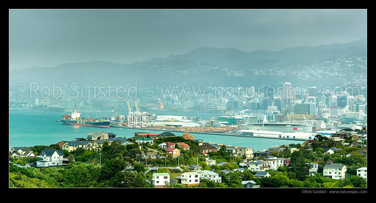 Image of Wellington City, Port, container terminal and harbour with approaching southerly weather front and storm at twilight. Khandallah suburb foreground. Panorama, Wellington, Wellington City District, Wellington Region, New Zealand (NZ) stock photo image