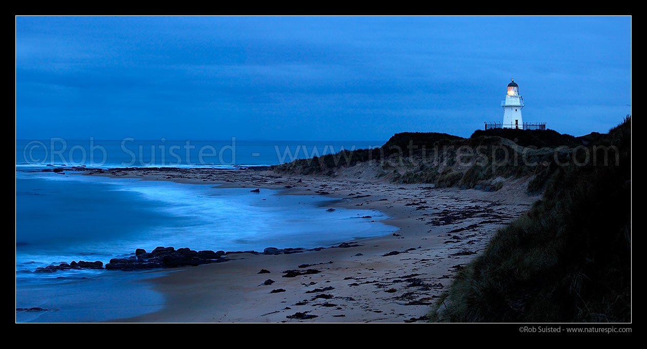 Image of Waipapa Point lighthouse and beach panorama on a moody evening, Fortrose, Southland District, Southland Region, New Zealand (NZ) stock photo image