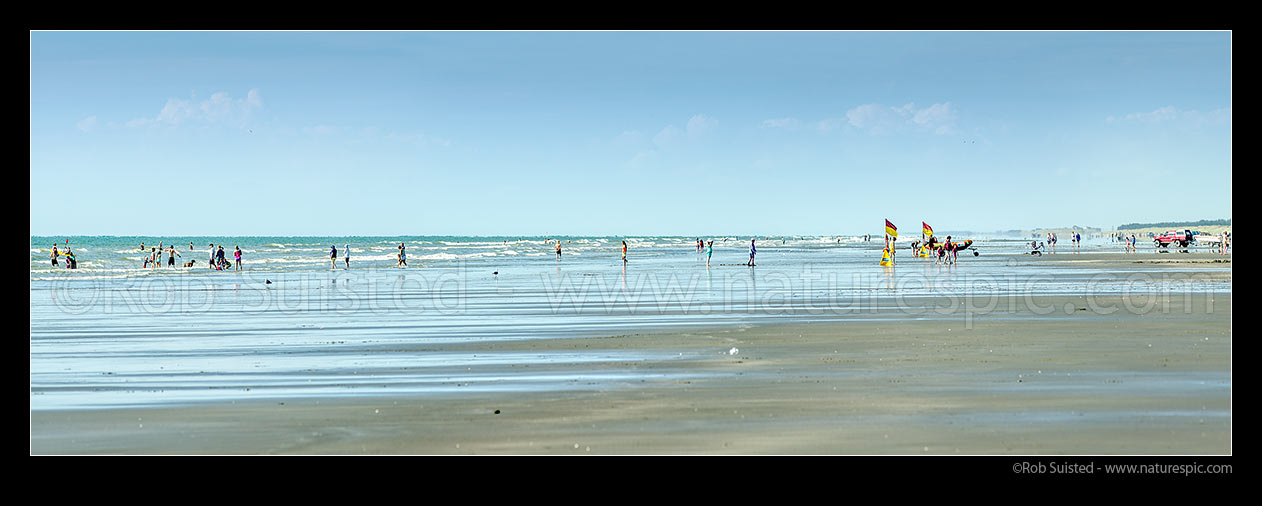 Image of Waitarere Beach full with swimmers and surf lifeguards on a hot summer day. Panorama, Waitarere Beach, Levin, Horowhenua District, Manawatu-Wanganui Region, New Zealand (NZ) stock photo image