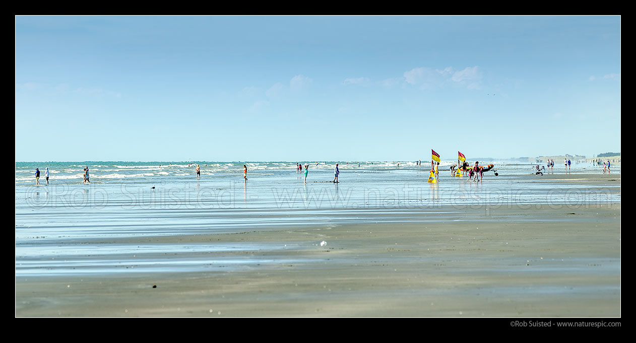 Image of Waitarere Beach full with swimmers and surf lifeguards on a hot summer day. Panorama, Waitarere Beach, Levin, Horowhenua District, Manawatu-Wanganui Region, New Zealand (NZ) stock photo image