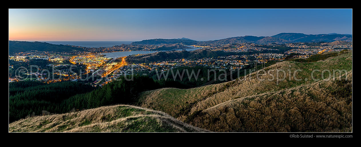 Image of Porirua City and Harbour at twilight. Titahi Bay centre, Cannons Creek, Waitangirua and Porirua East right. Plimmerton, Paremata and Kapiti Island distant. Panorama, Porirua, Porirua City District, Wellington Region, New Zealand (NZ) stock photo image