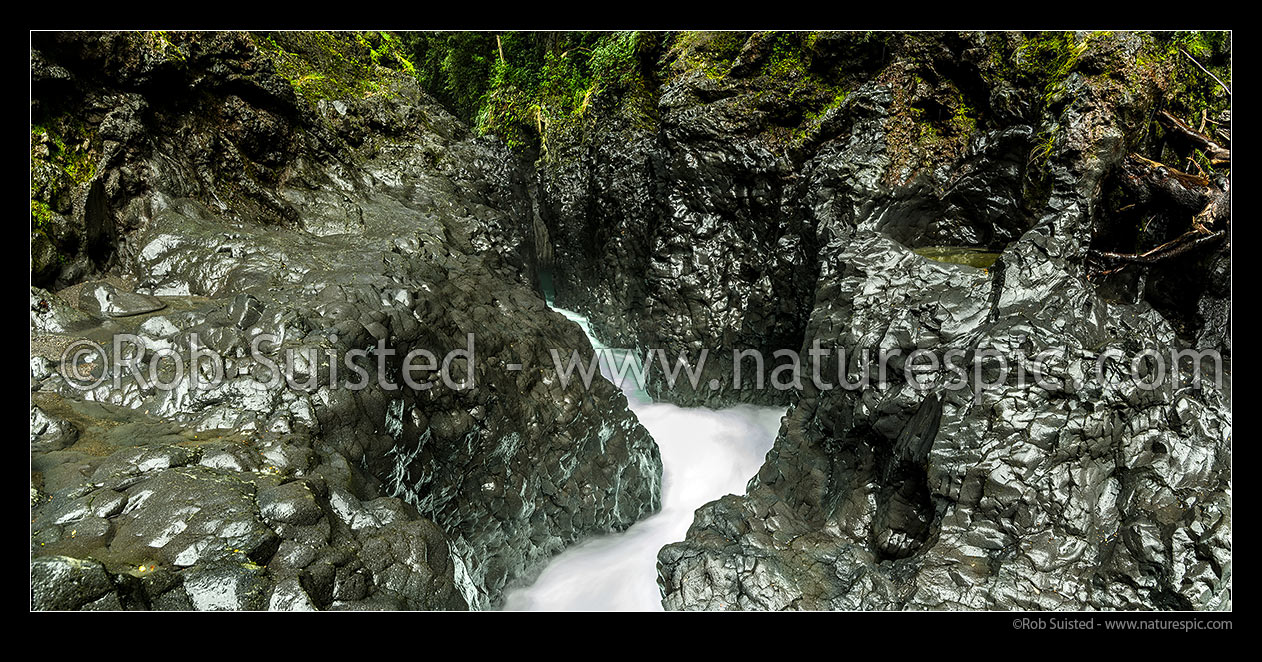 Image of Tongariro River passing through narrow water worn basalt rock chasm in Tree Trunk Gorge. Panorama, Kaimanawa Forest Park, Taupo District, Waikato Region, New Zealand (NZ) stock photo image