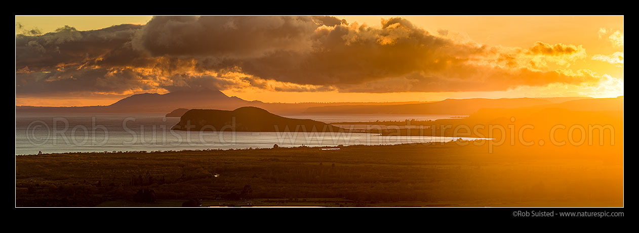 Image of Lake Taupo sunrise, looking past Motuoapa Peninsula and Motutaiko Island towards Mt Tauhara (1088m). Panorama, Turangi, Taupo District, Waikato Region, New Zealand (NZ) stock photo image