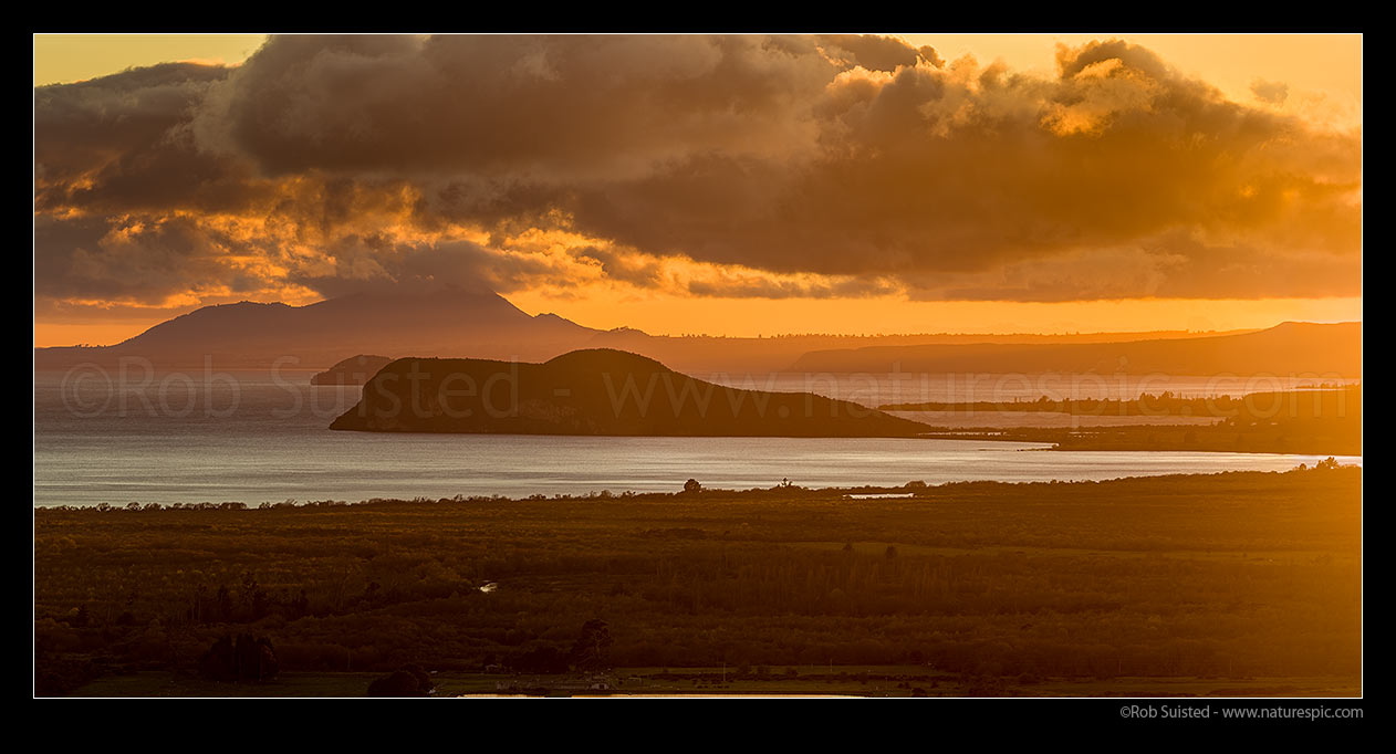 Image of Lake Taupo sunrise, looking past Motuoapa Peninsula and Motutaiko Island towards Mt Tauhara (1088m). Panorama, Turangi, Taupo District, Waikato Region, New Zealand (NZ) stock photo image