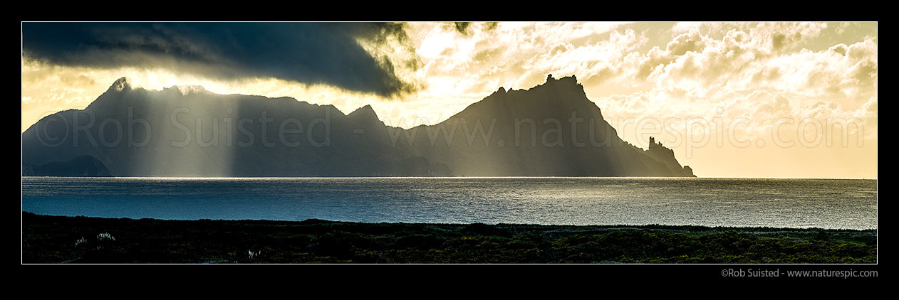 Image of Mt Lion (395m left) and Bream Head (476m right), moody rugged entrance to Whangarei Harbour from Bream Bay, on a moody morning. Panorama, Ruakaka, Whangarei District, Northland Region, New Zealand (NZ) stock photo image