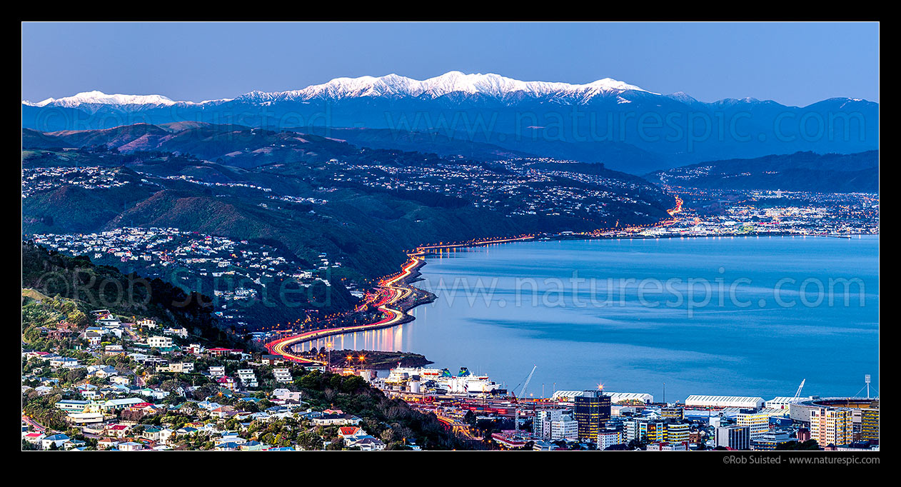 Image of Wellington city with Tararua Ranges above. Looking along SH1/SH2 to the Hutt Valley beyond. Wadestown, Thorndon and Kaiwharawhara in foreground. Hutt City and Petone beyond. Winter dusk panorama, Wellington, Wellington City District, Wellington Region, New Zealand (NZ) stock photo image