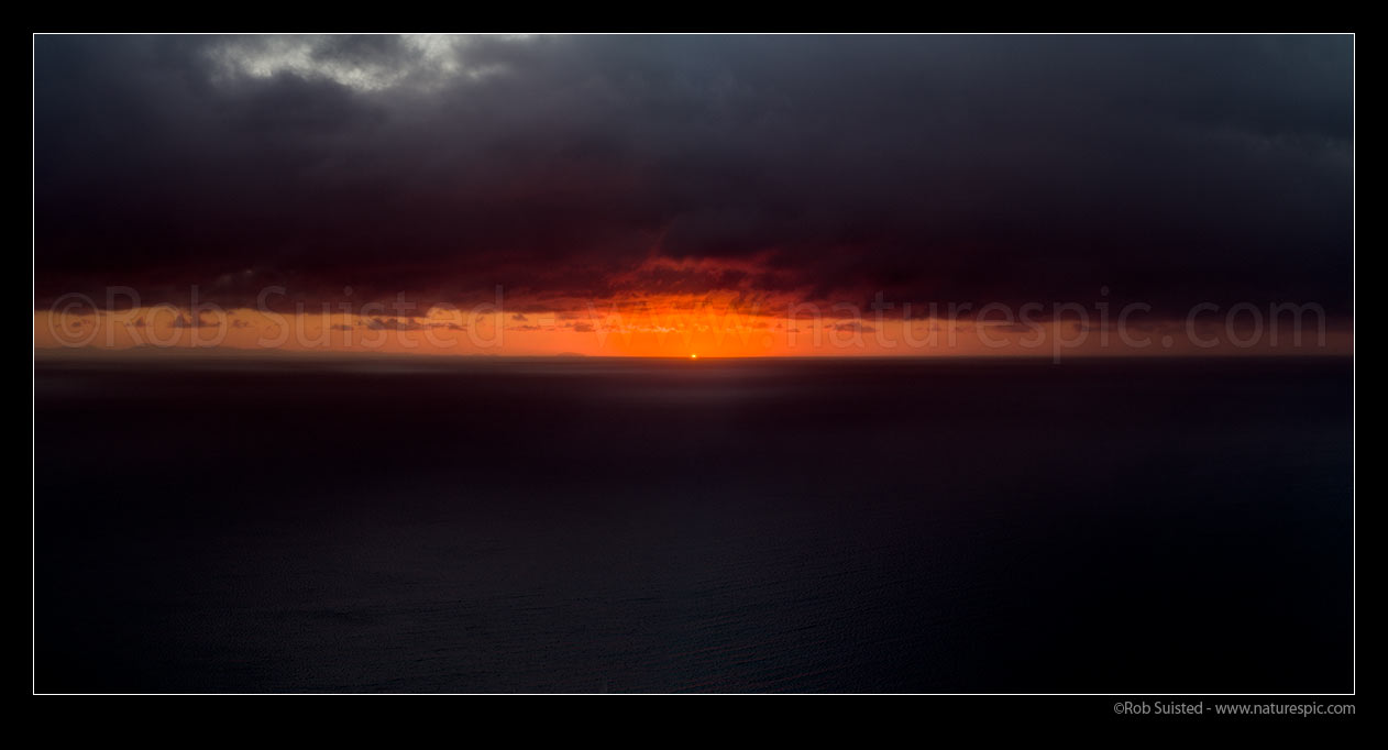 Image of Sunset over Cook Strait on stormy evening. Stephens (Takapourewa) Island visible left centre. Panorama, Paekakariki, Kapiti Coast District, Wellington Region, New Zealand (NZ) stock photo image