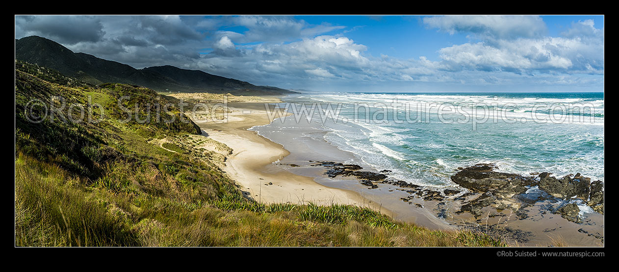 Image of Mitimiti Beach on West Coast of Northland. Panorama over golden sand, as moody weather breaks. Panorama, Mitimiti, Far North District, Northland Region, New Zealand (NZ) stock photo image