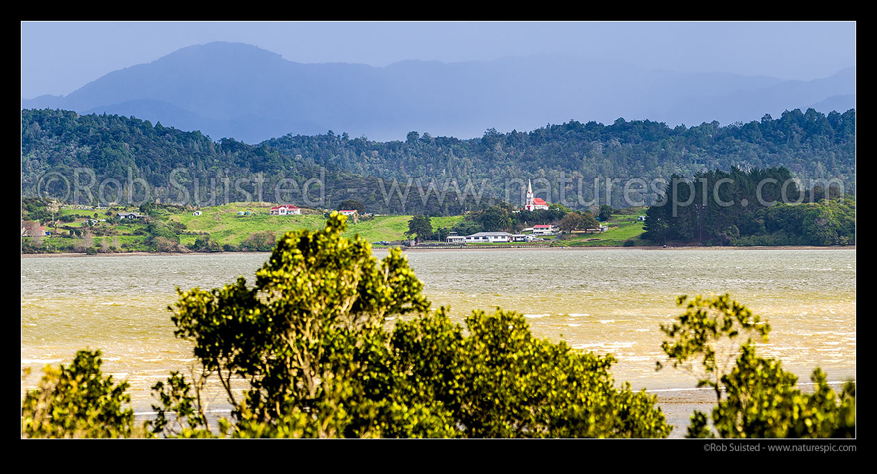 Image of Motukaraka Church. Catholic Church of Our Lady of the Assumption, historic Gothic style church built at Motukaraka Point in 1910 overlooking Rawene. Panorama with Panguru Range behind, Motukaraka, Hokianga Harbour, Far North District, Northland Region, New Zealand (NZ) stock photo image