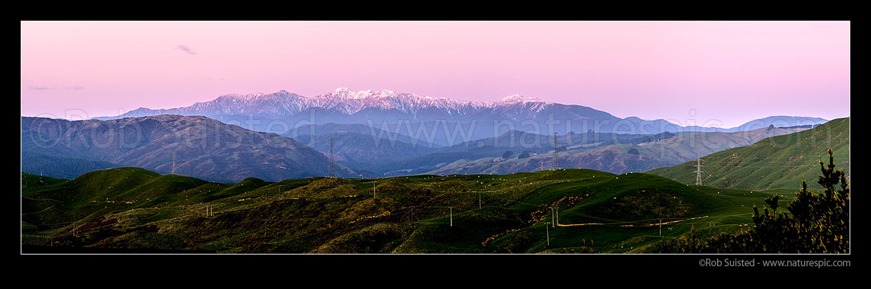 Image of Tararua Ranges, Southern Main Range. Mt Hector (1529m) highest point. Seen from Porirua, at sunset with winter snow. Panorama, Tararua Forest Park, Porirua City District, Wellington Region, New Zealand (NZ) stock photo image