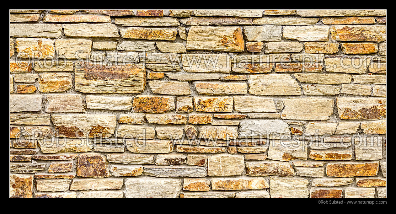 Image of Schist stonewall. Schist rock layered into decorative stone wall. Red schist, New Zealand (NZ) stock photo image