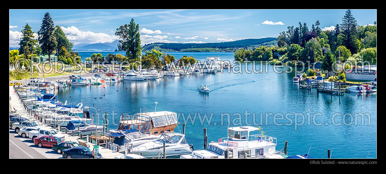 Image of Lake Taupo marina with boats and yachts on the start of the Waikato River. Tongariro National Park and Acacia Bay beyond. Panorama, Taupo, Taupo District, Waikato Region, New Zealand (NZ) stock photo image