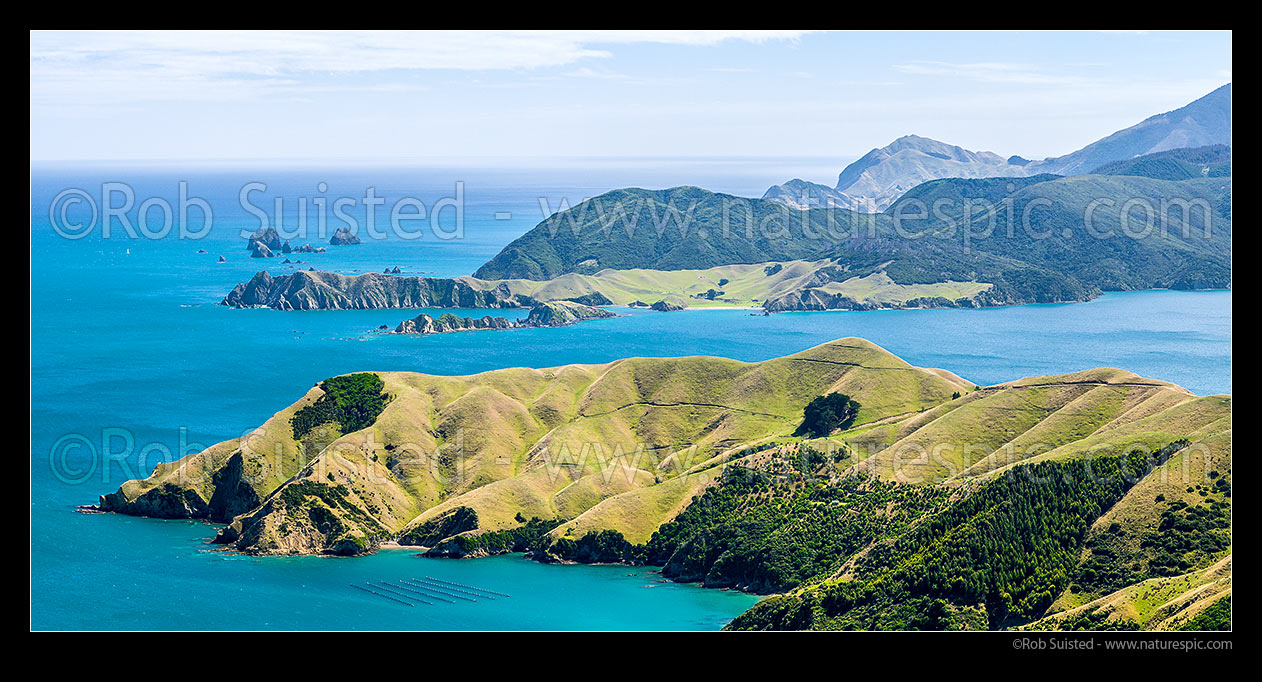 Image of D'Urville Island beyond French Pass farmland. Okuri Bay foreground, with Current Basin, Ohana Bay, Le Brun Peninsula, Hautai Island centre. Paddock Rocks and Tasman Bay behind. Panorama, French Pass, Marlborough Sounds, Marlborough District, Marlborough Region, New Zealand (NZ) stock photo image