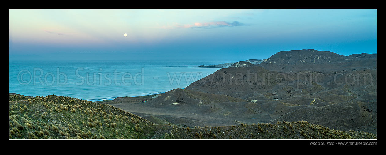 Image of Cape Campbell Lighthouse with full moon rising over Clifford Bay. Twilight panorama, Clifford Bay, Marlborough District, Marlborough Region, New Zealand (NZ) stock photo image