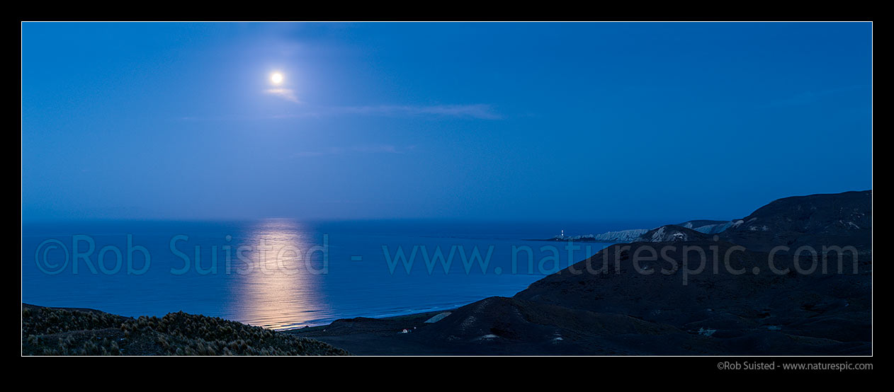 Image of Full moon rising over Clifford Bay and Cape Campbell lighthouse. Twilight panorama, Clifford Bay, Marlborough District, Marlborough Region, New Zealand (NZ) stock photo image