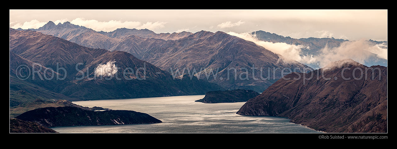 Image of Lake Wanaka panorama. Mou Waho Island centre. Minaret Burn centre, Minaret Peaks (2193m) far left, Roys Peninsula (bottom left, and The Peninsula at right. Panorama, Wanaka, Queenstown Lakes District, Otago Region, New Zealand (NZ) stock photo image