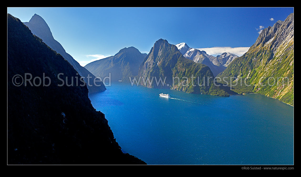 Image of Milford Sound aerial with cruise ship. Mitre Peak far right, The Lion and Mt Pembroke (2015m) centre, Harrison Valley right. Panorama, Fiordland National Park, Southland District, Southland Region, New Zealand (NZ) stock photo image