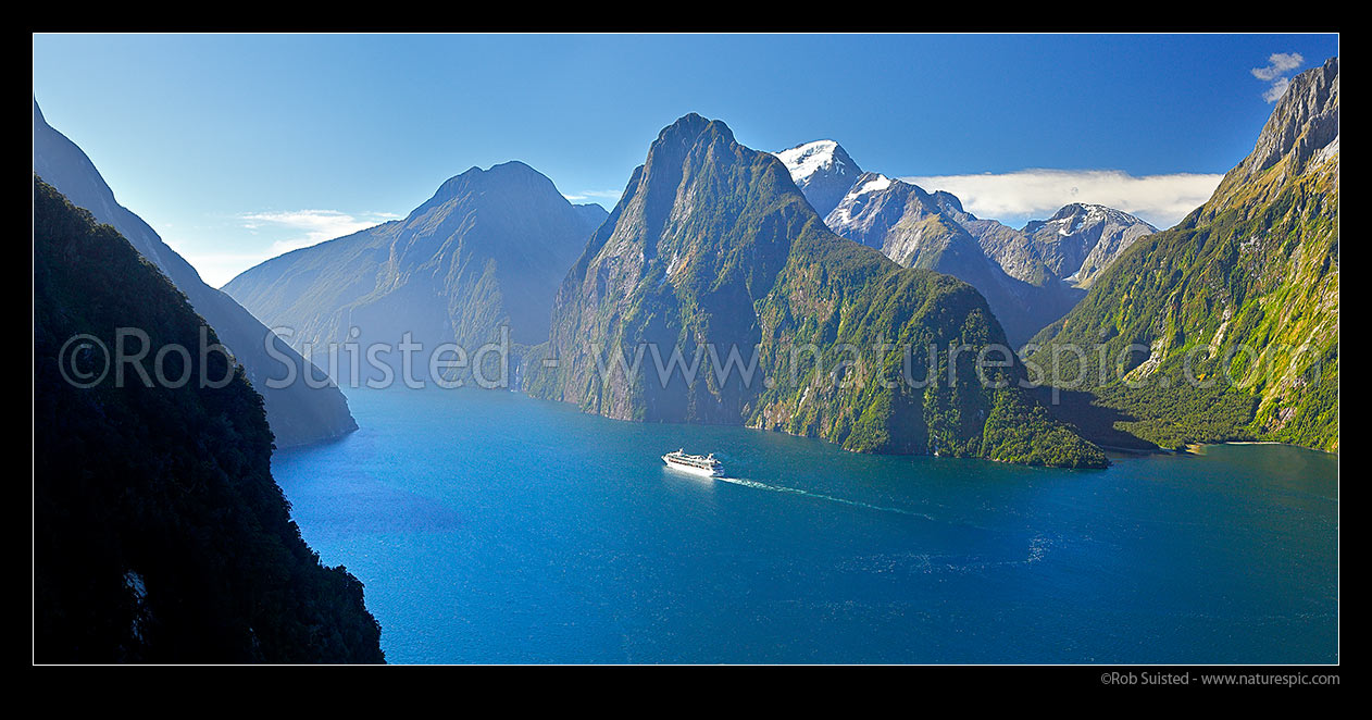 Image of Milford Sound aerial with cruise ship. Mitre Peak far right, The Lion and Mt Pembroke (2015m) centre, Harrison Valley right. Panorama, Fiordland National Park, Southland District, Southland Region, New Zealand (NZ) stock photo image