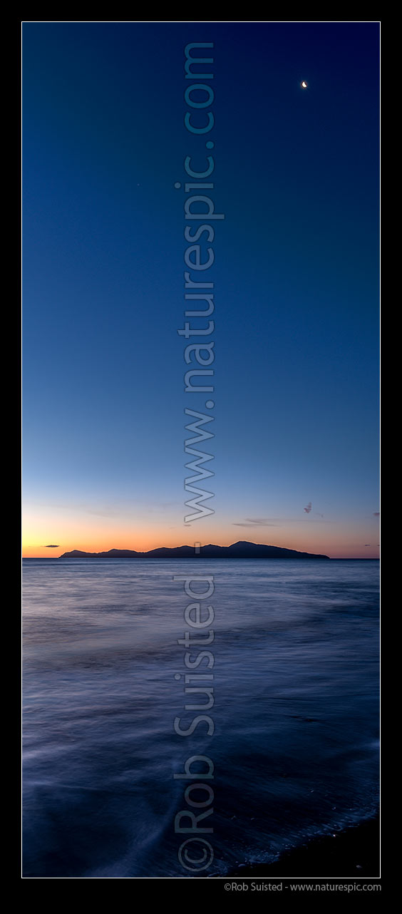 Image of Kapiti Island after sunset, with moon high above. Paekakariki's Whareroa Beach, Paekakariki, Kapiti Coast District, Wellington Region, New Zealand (NZ) stock photo image