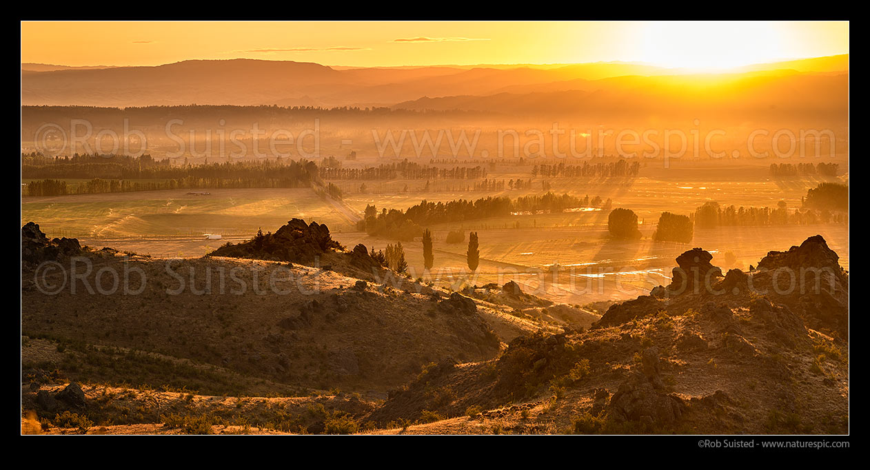 Image of Central Otago sunrise over Earnscleugh and Blackmans, with Alexandra and the Clutha (Mata-Au) River plains beyond. Panorama, Alexandra, Central Otago District, Otago Region, New Zealand (NZ) stock photo image