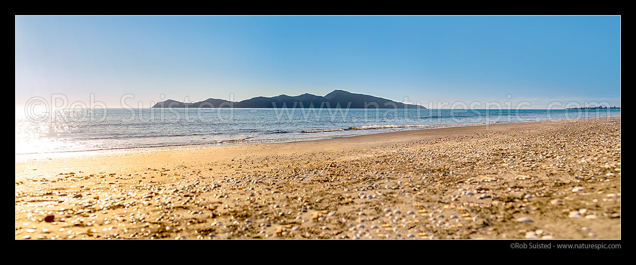 Image of Kapiti Island Nature Reserve, seen from Paekakariki on a glistening sunny day. Panorama, Paekakariki, Kapiti Coast District, Wellington Region, New Zealand (NZ) stock photo image