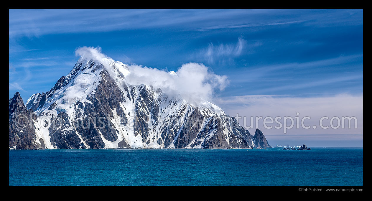 Image of Elephant Island, ice-covered mountainous island in the outer reaches of the South Shetland Islands.  Cape Valentine prominent at left. Seen from the east. Panorama, Elephant Island, Antarctica Region, Antarctica stock photo image