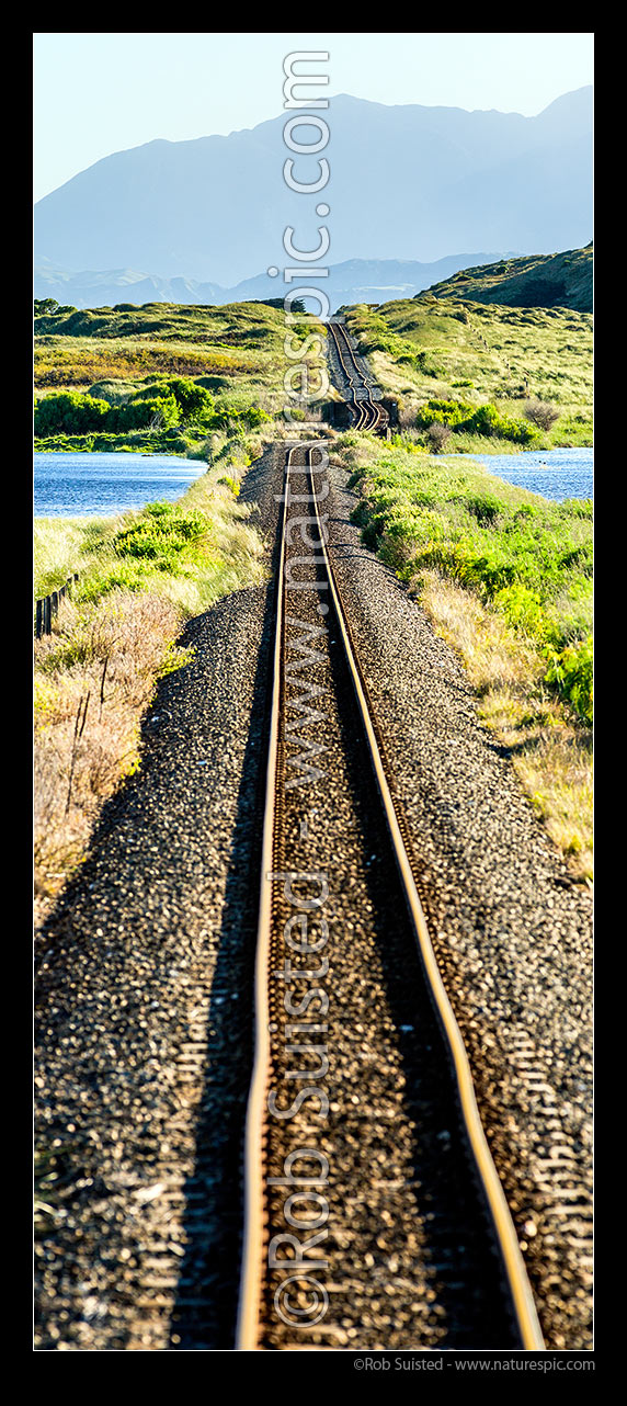 Image of Earthquake movement on strike slip Kekerengu Fault moved 9 metres left, pushing up a large rise on a dead straight flat railway line. Seaward Kaikoura Mountains beyond. Kaikoura M7.8 earthquake. Vertical panorama, Tirohanga, Kekerengu, Kaikoura District, Canterbury Region, New Zealand (NZ) stock photo image