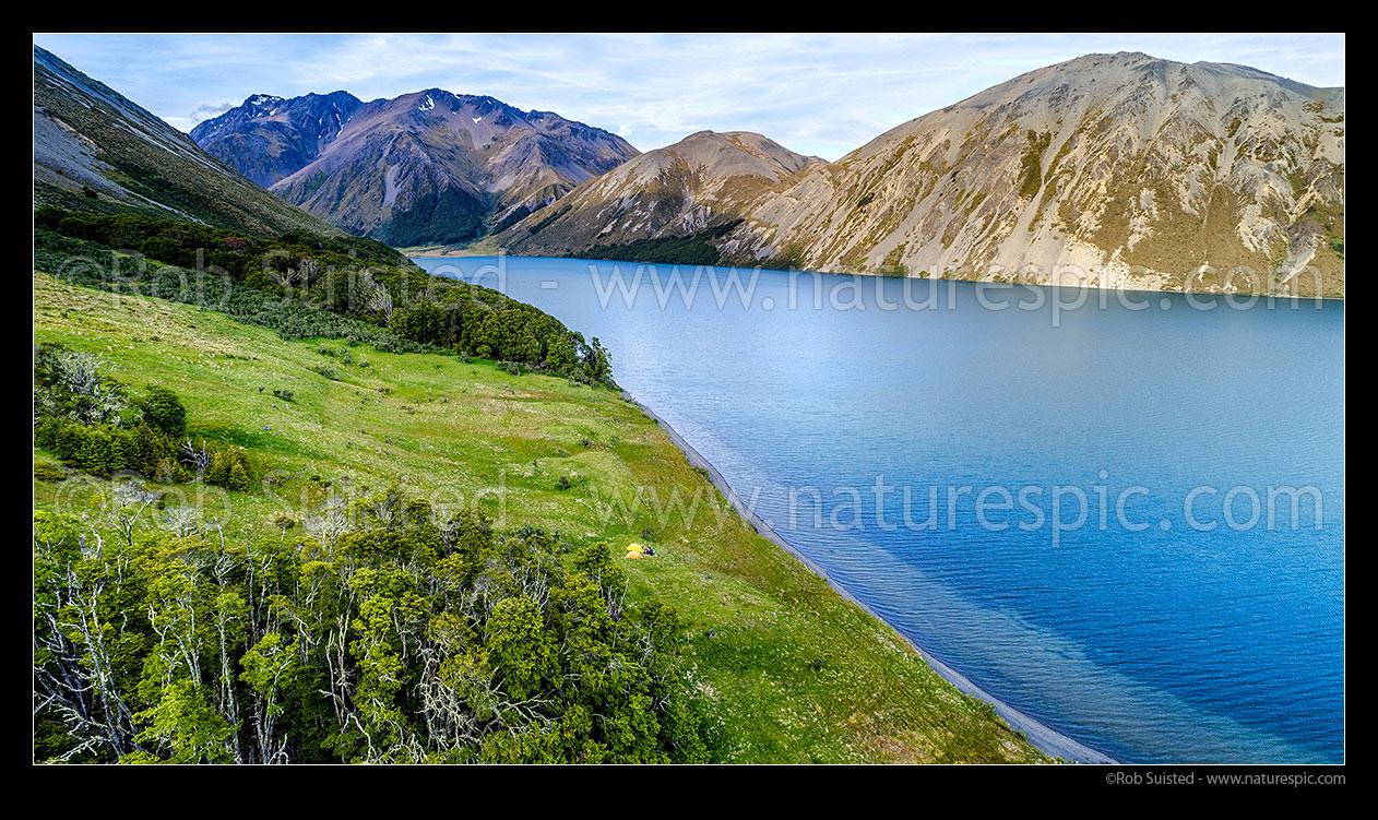 Image of Lake Tennyson Scenic Reserve near the head of the Clarence River, inland Marlborough, with people tent camping on shoreline. Crimea Range and Mt Southey (1691m) beyond. Aerial panorama, Molesworth Station, Hurunui District, Canterbury Region, New Zealand (NZ) stock photo image