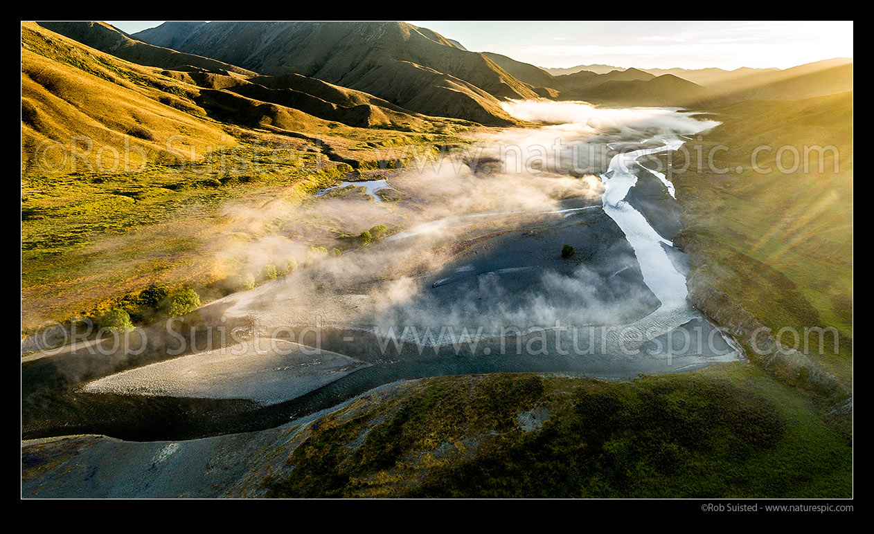 Image of Clarence River braids under early morning fog, as it winds down past the Acheron confluence. Bullen Hills beyond. Aerial panorama view at sunrise, Molesworth Station, Marlborough District, Marlborough Region, New Zealand (NZ) stock photo image