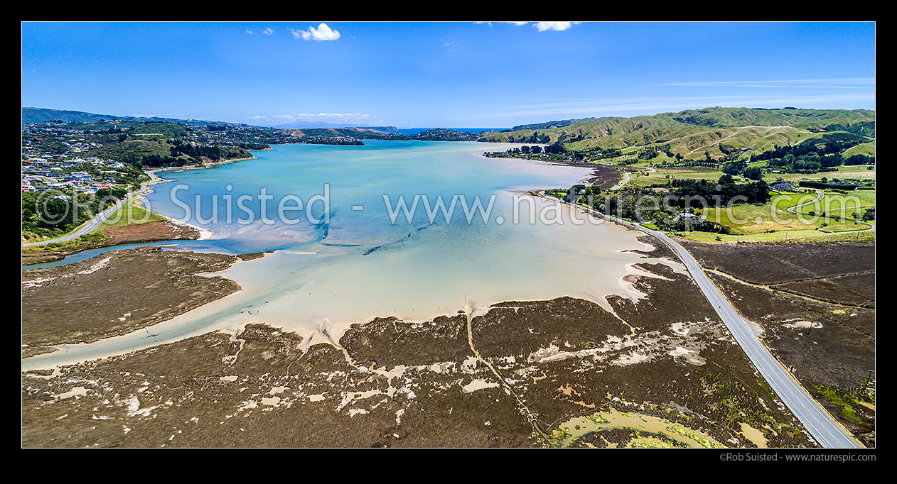 Image of Pauatahanui Inlet of Porirua Harbour from air. Pauatahanui Stream and Whitby far left, Wildlife Reserve below, and Grays Road, Ration Point right. Aerial view panorama, Pauatahanui, Porirua City District, Wellington Region, New Zealand (NZ) stock photo image