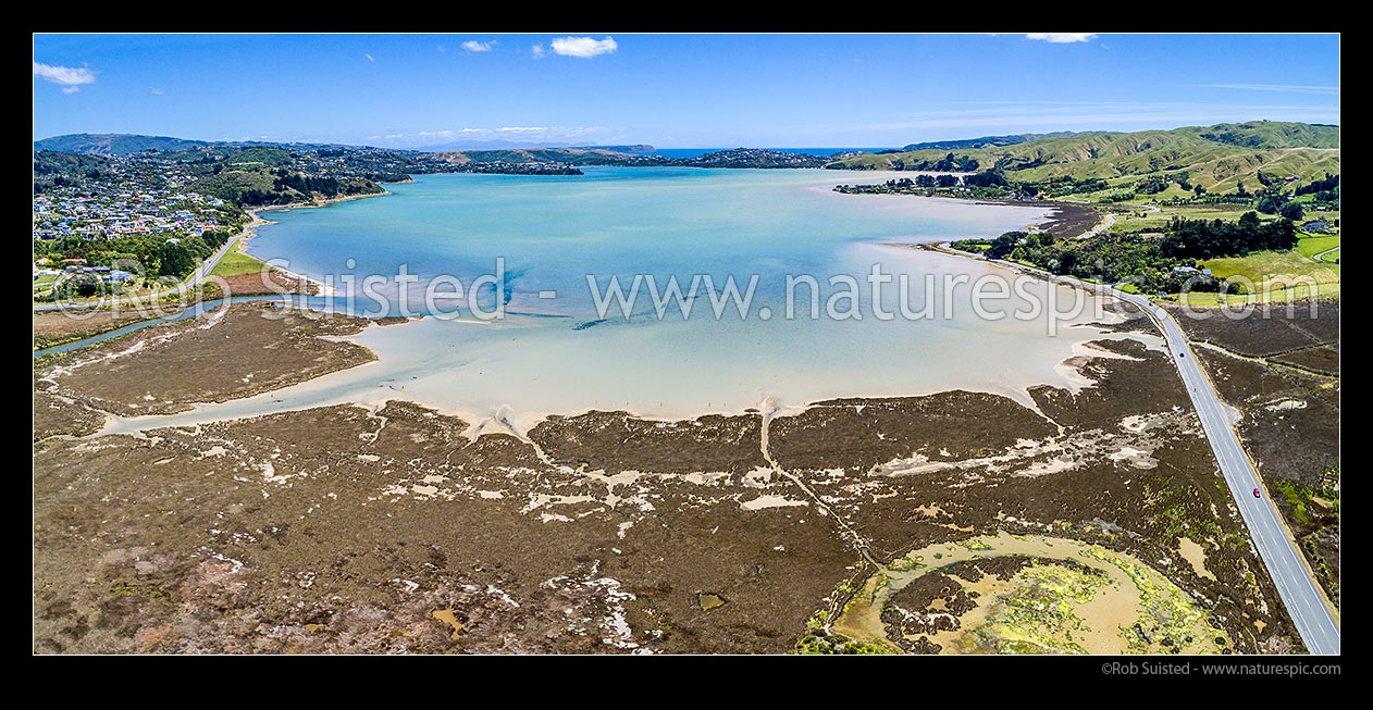 Image of Pauatahanui Inlet of Porirua Harbour from air. Pauatahanui Stream and Whitby far left, Wildlife Reserve below, and Grays Road, Ration Point right. Aerial view panorama, Pauatahanui, Porirua City District, Wellington Region, New Zealand (NZ) stock photo image