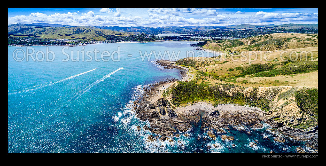 Image of Entrance to Porirua Harbour with boats returning home. Plimmerton at left, Onehunga Bay and Whitireia Park right, with Pauatahanui Inlet in distance. Aerial panorama, Titahi Bay, Porirua City District, Wellington Region, New Zealand (NZ) stock photo image