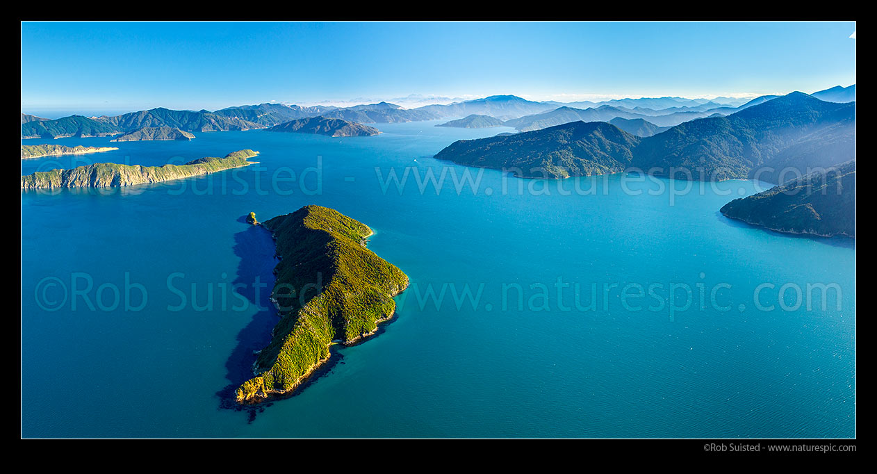 Image of Motuara Island in Outer Queen Charlotte Sound (Totaranui), with Long Island (Kokomohua) and Arapawa at left. Ship Cove far right, Kaikoura Ranges distant. Aerial panorama, Marlborough Sounds, Marlborough District, Marlborough Region, New Zealand (NZ) stock photo image