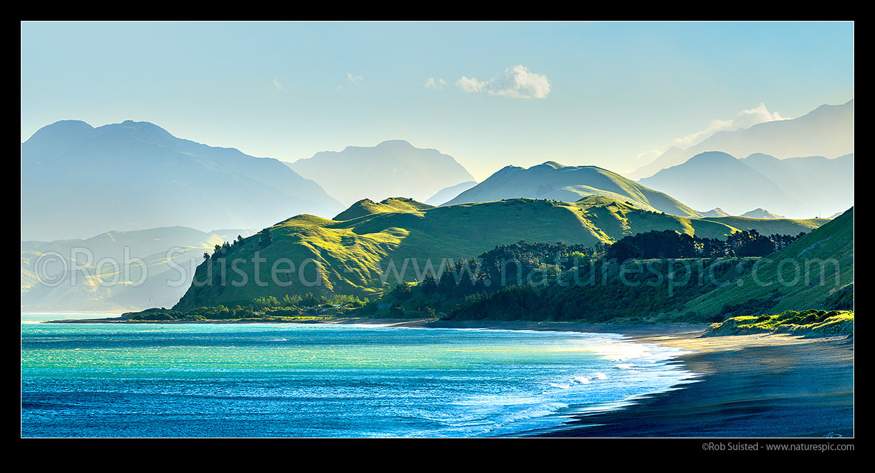 Image of Kaikoura Coastline at Kekerengu. Late afternoon sun on hills and Seaward Kaikoura Ranges, beach and coastal farmland. Panorama, Kekerengu, Kaikoura District, Canterbury Region, New Zealand (NZ) stock photo image